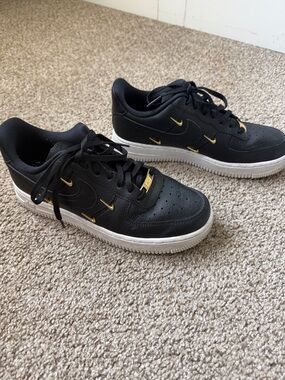 Nike Black Low-Top Sneakers with Gold Accents